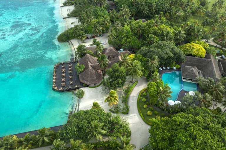 Aerial view of Adaaran Select Hudhuranfushi resort with pools and tropical greenery.
