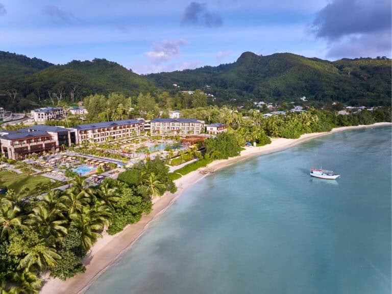 Canopy by Hilton Seychelles beachfront resort with lush greenery and mountain views.