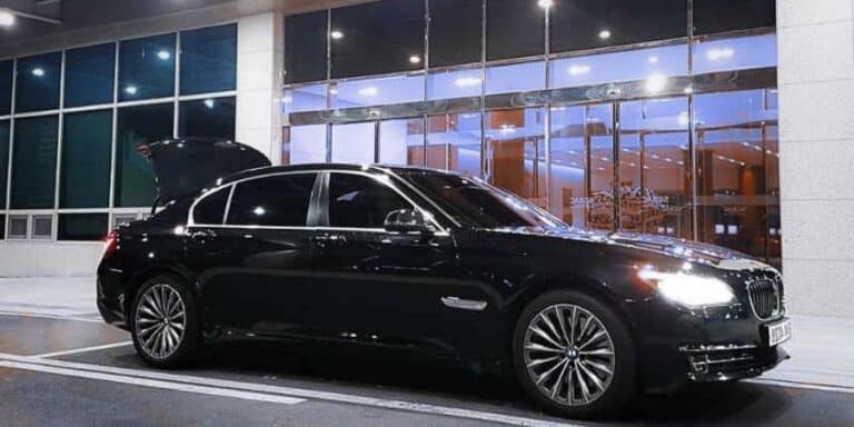 Luxury black sedan at Mauritius airport for transfers.